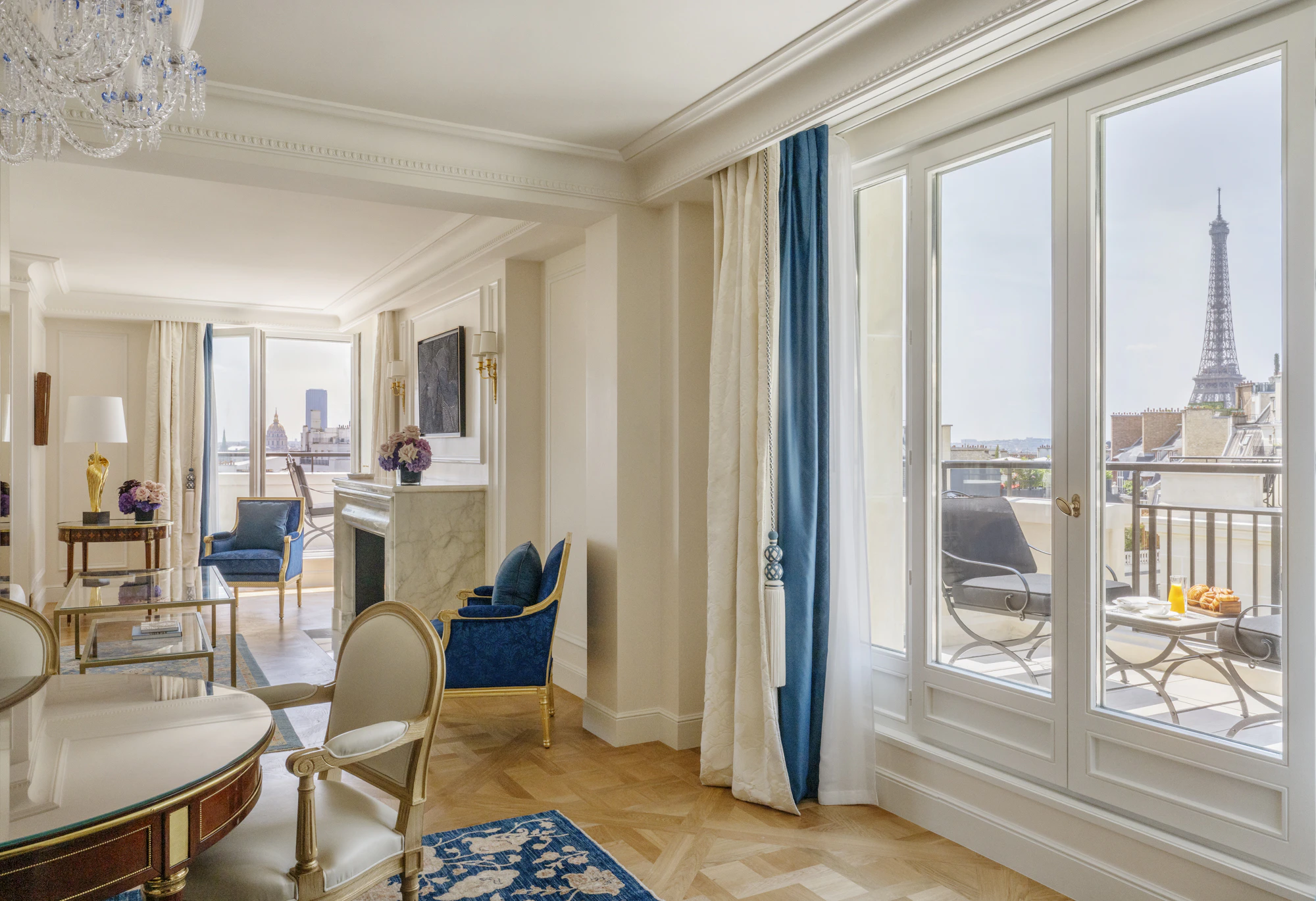A suite at Four Seasons Hotel George V, Paris, with views over the Eiffel Tower and city rooftops.