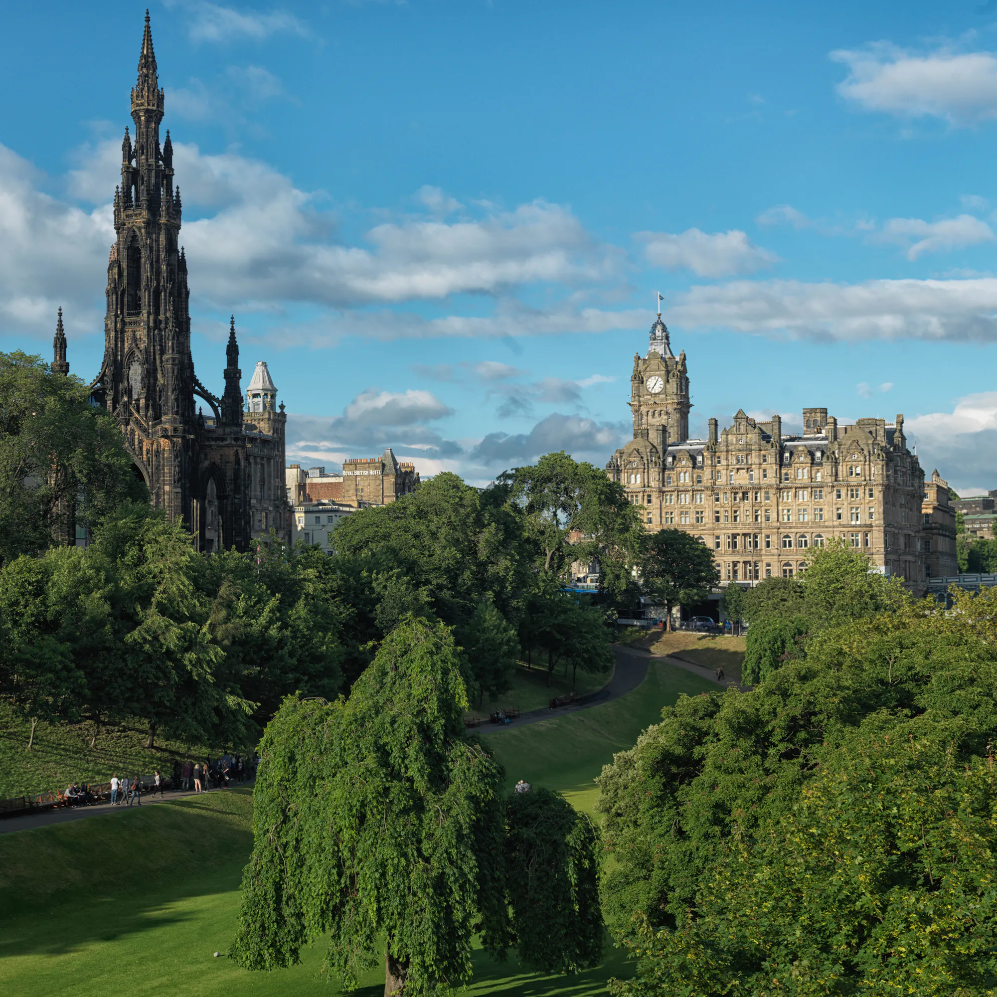 The Balmoral hotel's clock tower seen past the Scott Monument and Princes Street Gardens.