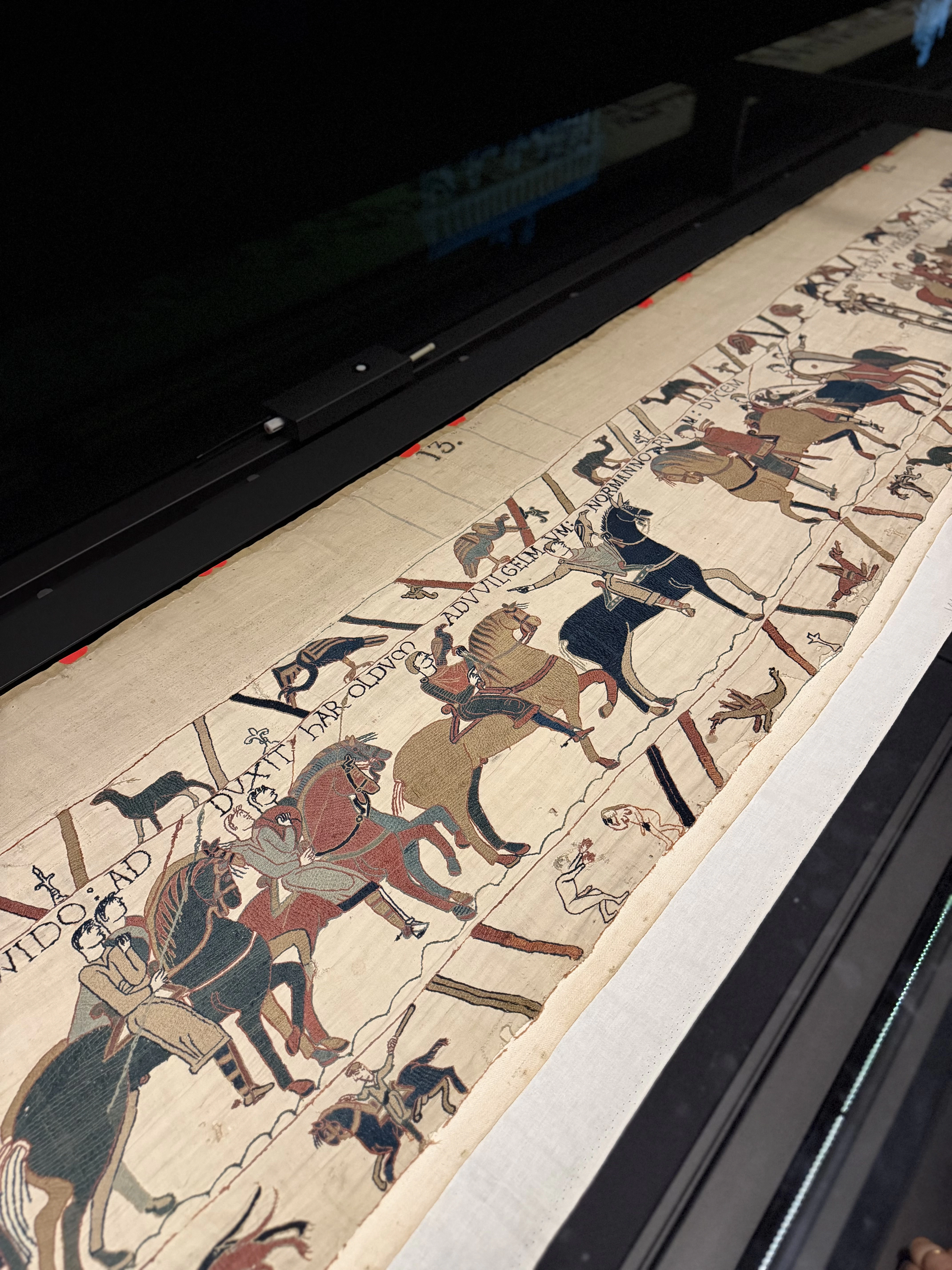 The Bayeux Tapestry on display at the British Museum, its stitched knights and Latin captions.